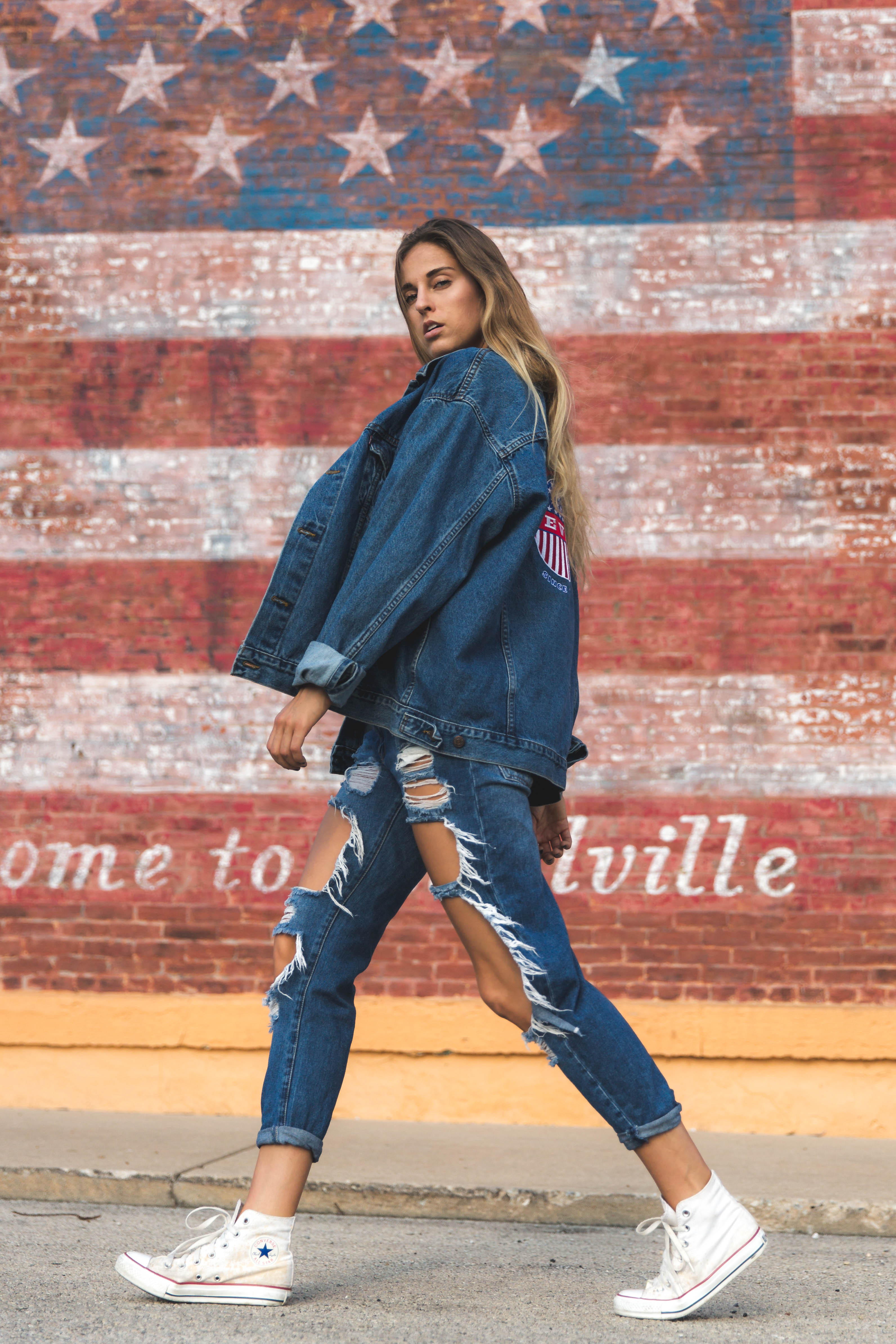 Brandy Melville fashion portrait in denim against an American flag mural