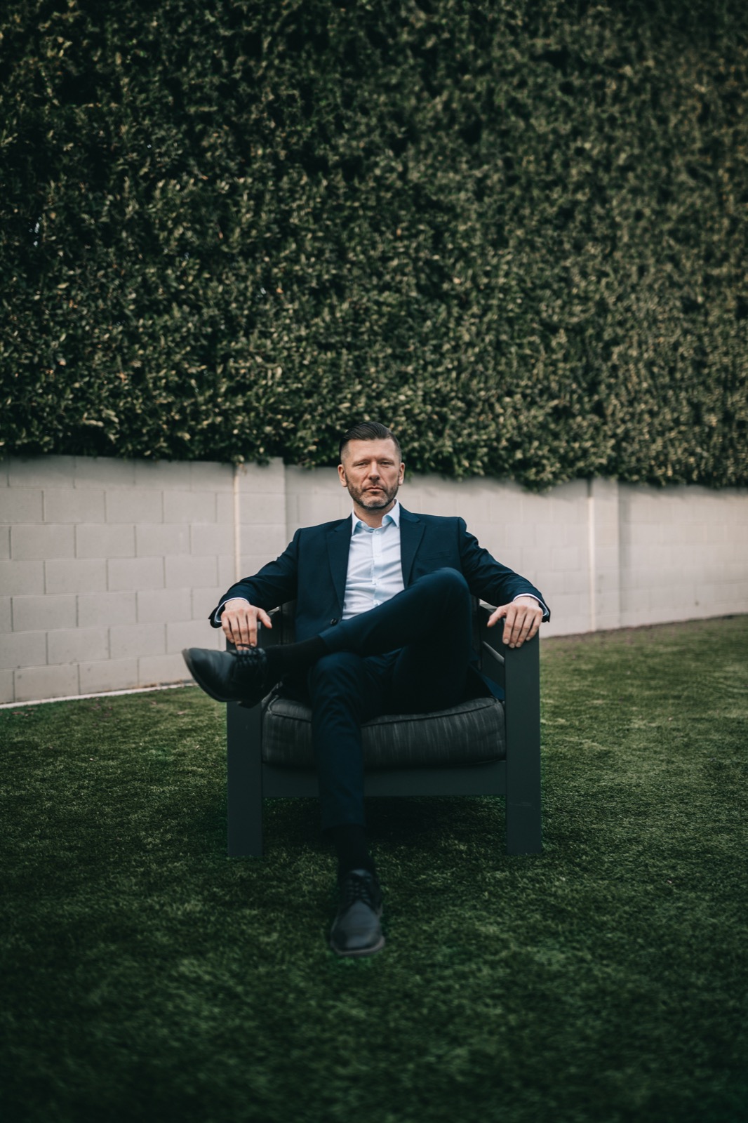 Business portrait of a man in a suit seated outdoors