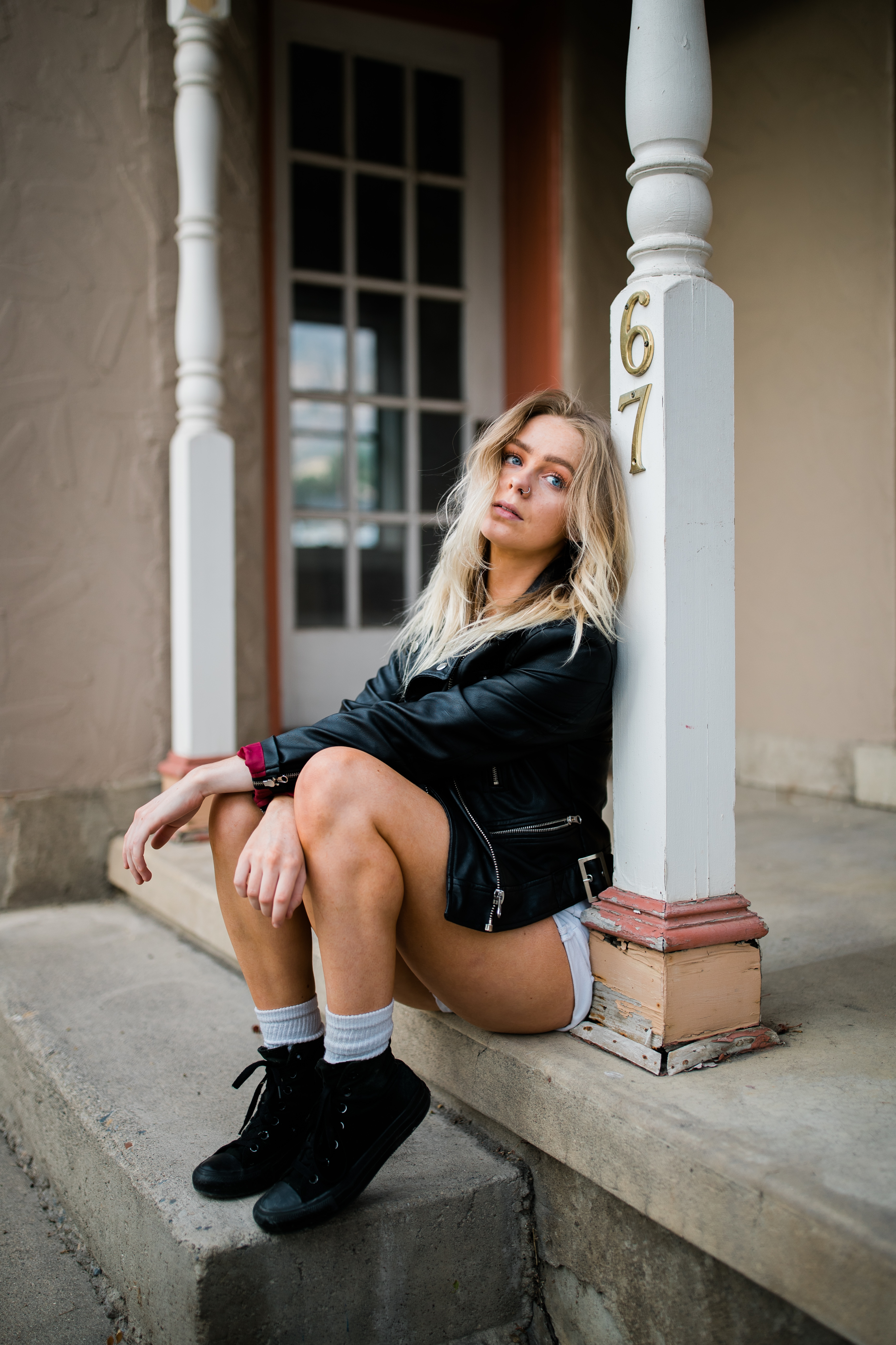 Personal brand portrait of a woman seated on a porch